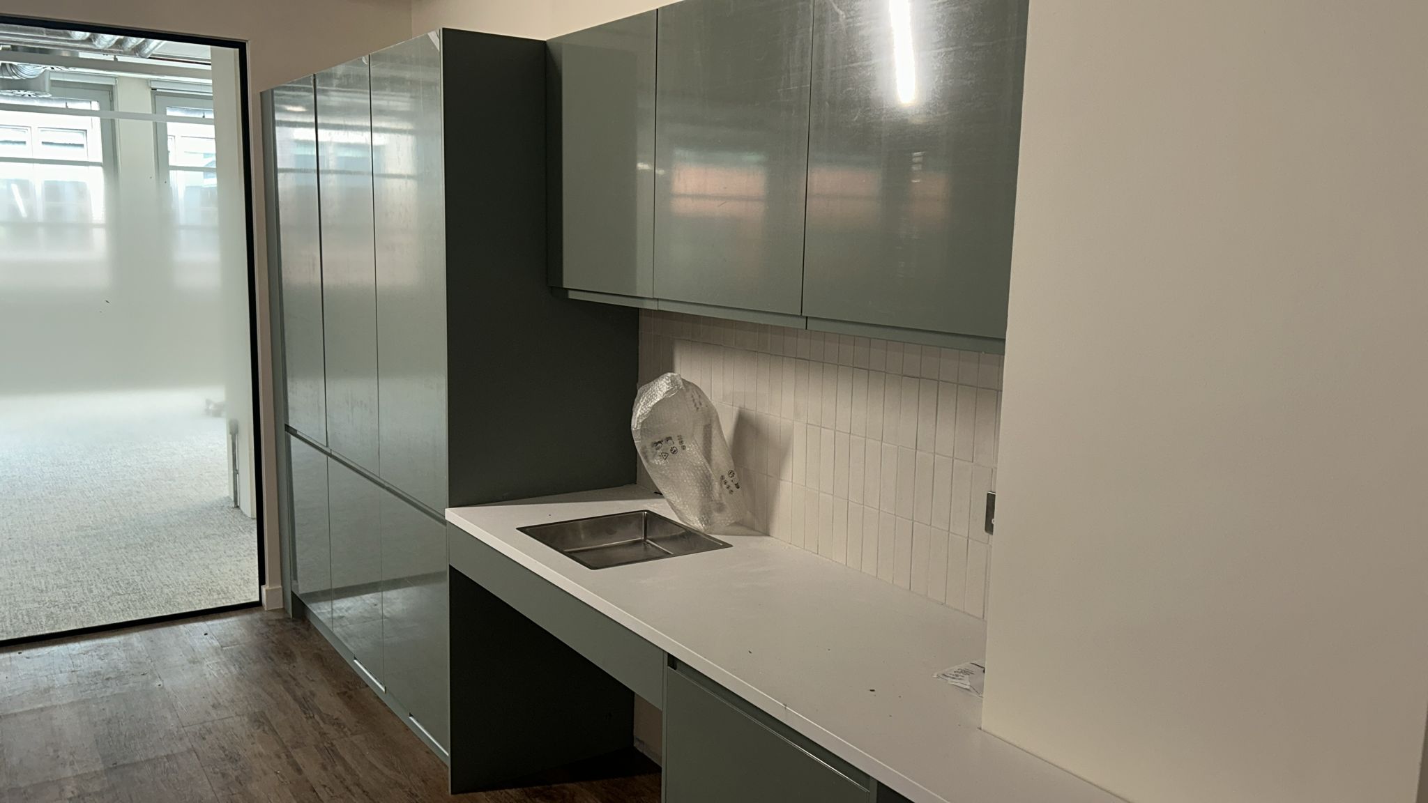 Howdens Clerkenwell tea-point with sage cabinetry and HiMacs worktop